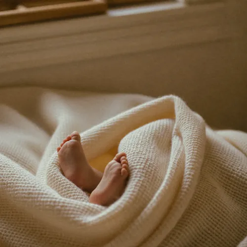 Emmas winzige Füße in der Kuscheldecke